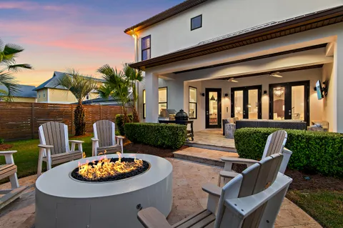 a view of a house with backyard and sitting area