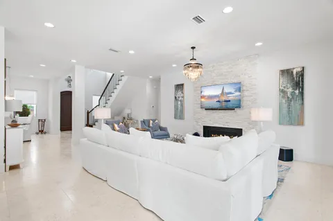 a bedroom with bed a couch and chandelier
