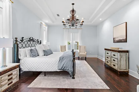 a bedroom with a bed and a chandelier