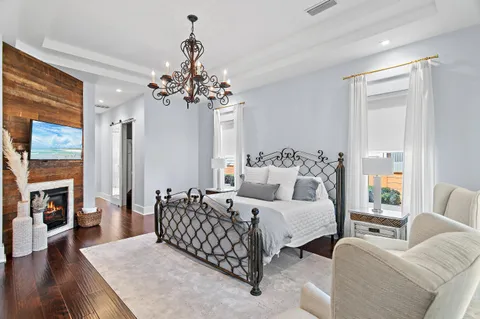 a bedroom with a bed and a chandelier