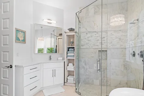 a bathroom with a granite countertop toilet sink and mirror
