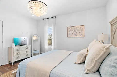 a bedroom with a bed furniture and a flat screen tv