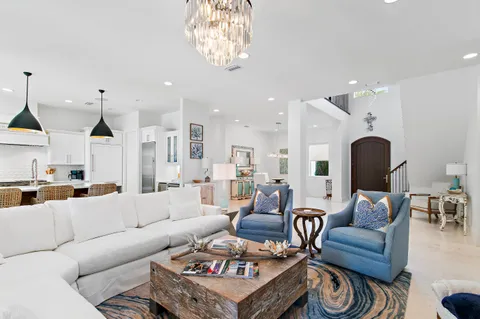 a living room with furniture and a chandelier