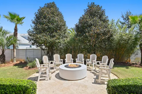 a view of a patio with table and chairs potted plants and tree