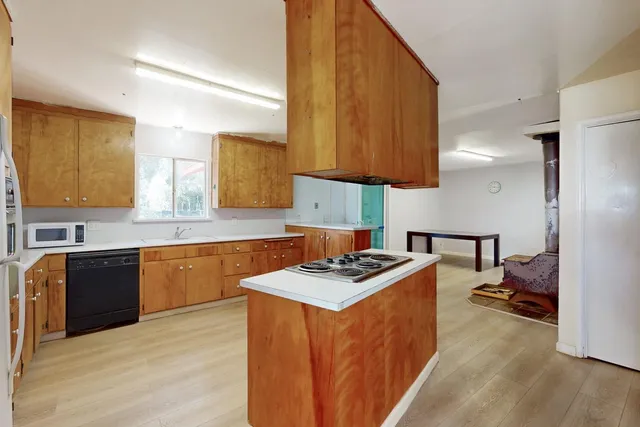 a kitchen with stainless steel appliances granite countertop a stove a sink and a refrigerator