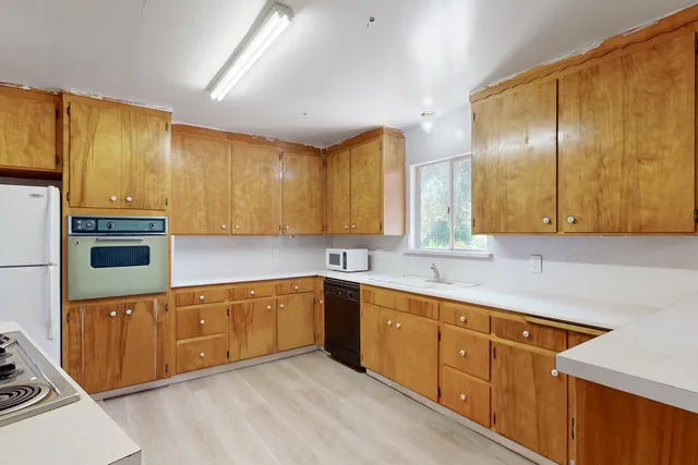 a kitchen with a stove a sink and a refrigerator