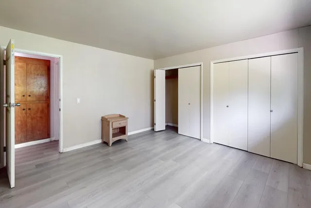 a view of a lake with boats and trees around