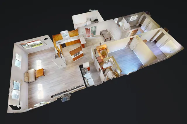 a view of a field with trees in the background