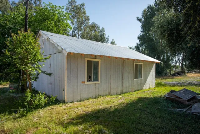 a view of a livingroom with furniture and a window
