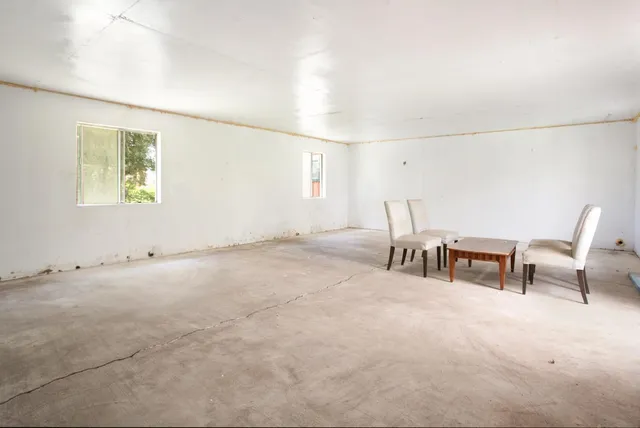 wooden floor fireplace and windows in an empty room