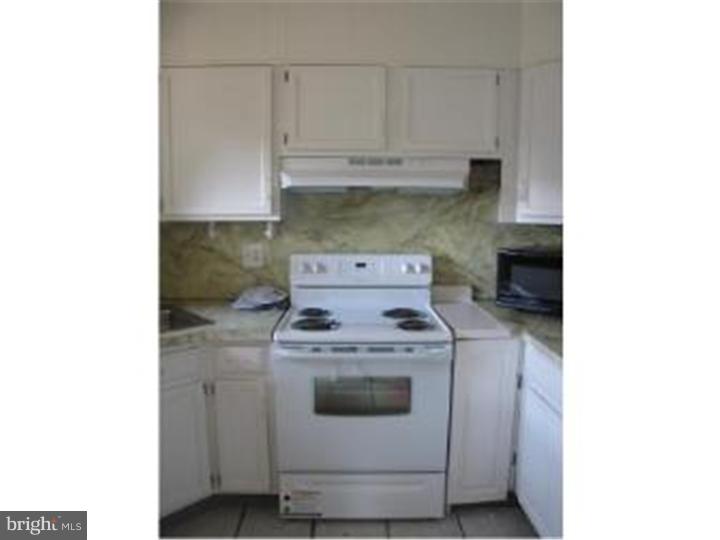 18 Tinder Road Levittown, PA 19056 - Photo 12 of 25 a stove top oven sitting inside of a kitchen