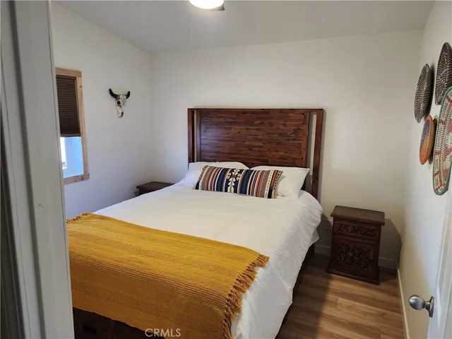 a bed sitting in a bedroom next to a window