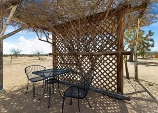 a view of a roof deck with table and chairs