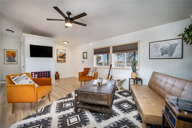 a living room with furniture fireplace and a flat screen tv