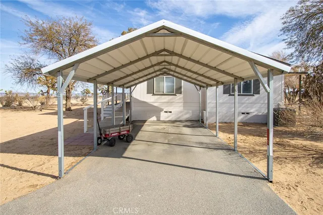 a view of a house with a small yard and wooden fence