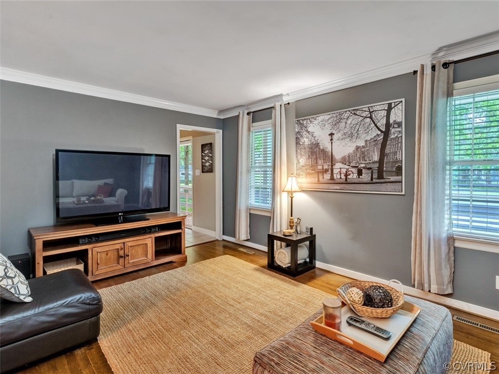 13631 Castleway Road Midlothian, VA 23114 - Photo 16 of 37 Living room/den area with crown molding and wood f