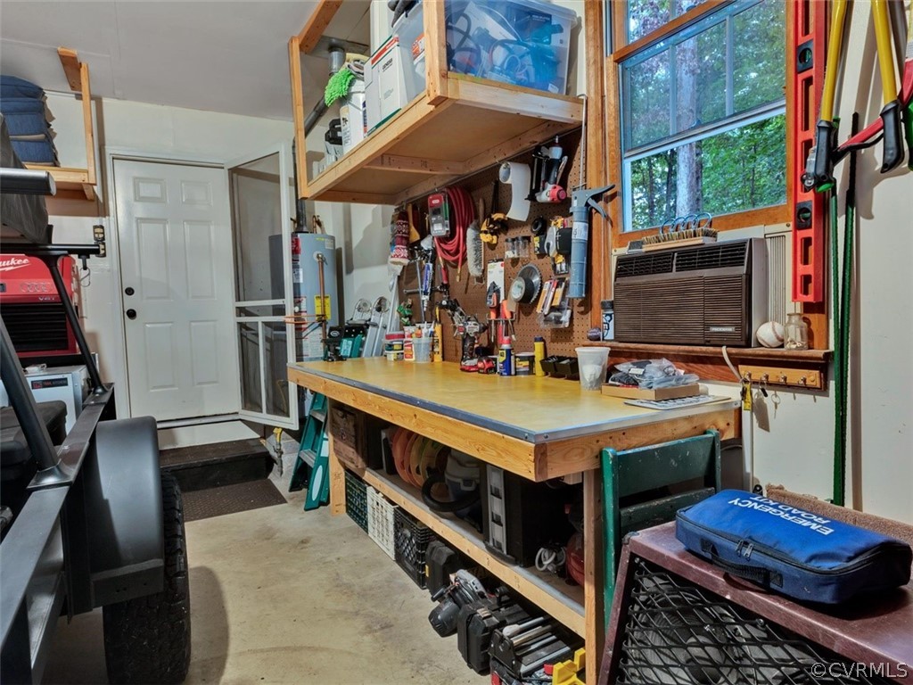 13631 Castleway Road Midlothian, VA 23114 - Photo 29 of 37 Garage with workbench and extra storage space abov