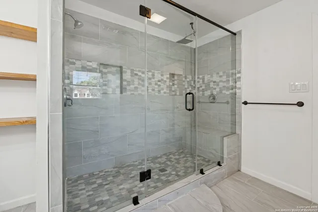 a bathroom with a shower and sink