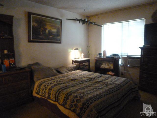917 Appleton Road Simi Valley, CA 93065 - Photo 11 of 14 a bedroom with a bed and wooden floor