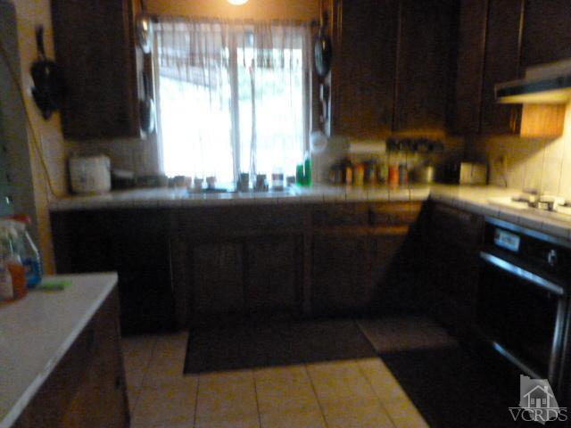 917 Appleton Road Simi Valley, CA 93065 - Photo 6 of 14 a kitchen with a sink a window and cabinets