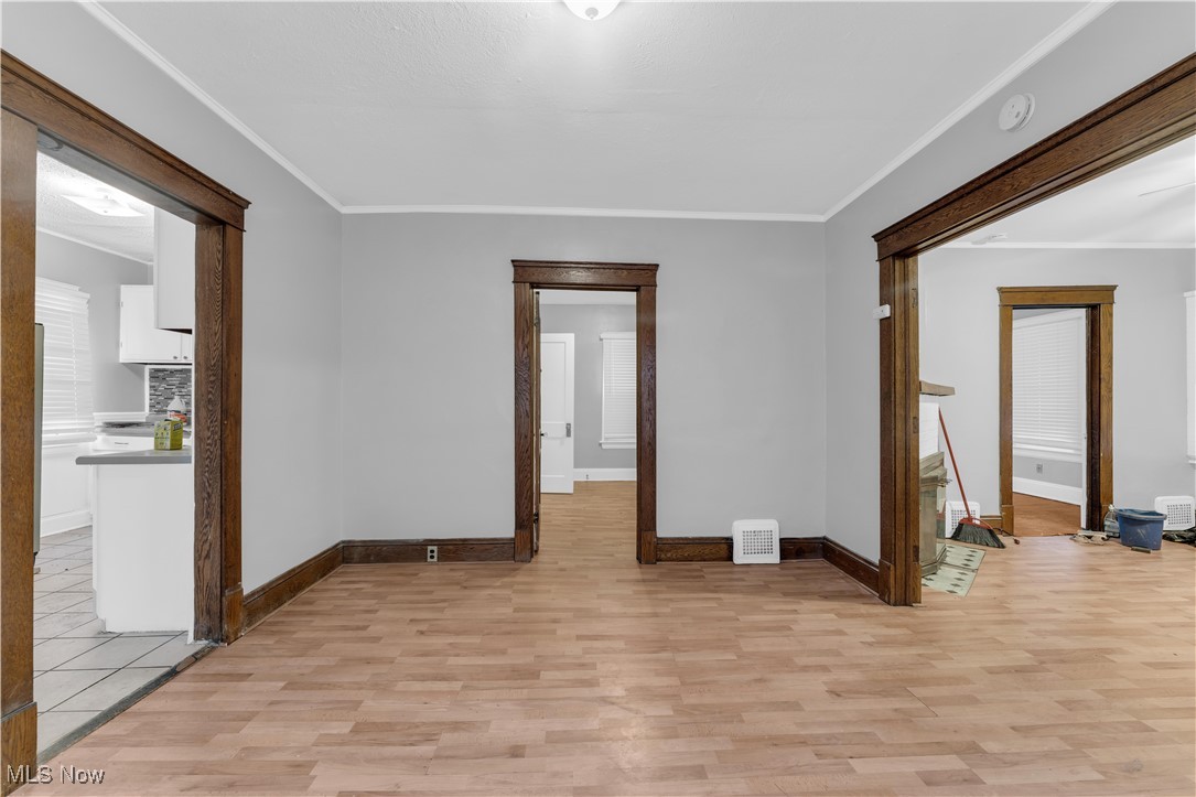 4408 Alpha Avenue Cleveland, OH 44105 - Photo 27 of 41 Empty room featuring crown molding and light hardwood / wood-style flooring
