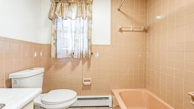 a bathroom with a toilet and shower