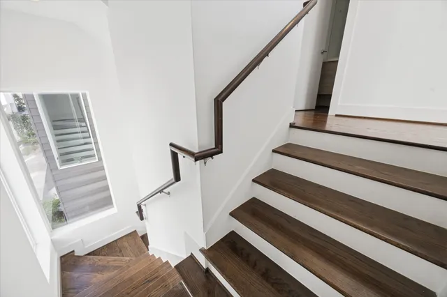 a view of entryway with wooden floor and stairs