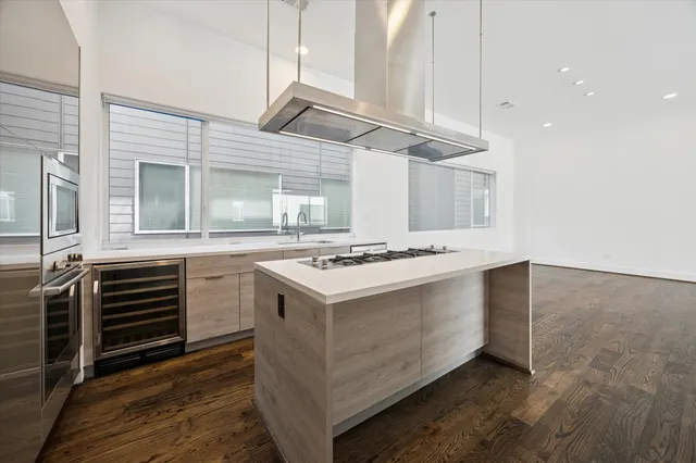 a kitchen with kitchen island granite countertop a sink and a stove