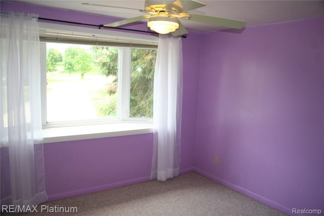 4250 Crandall Road Howell, MI 48855 - Photo 43 of 57 Large box bay window and ceiling fan in this lower level room. Was used as a bedroom but there is no closet.