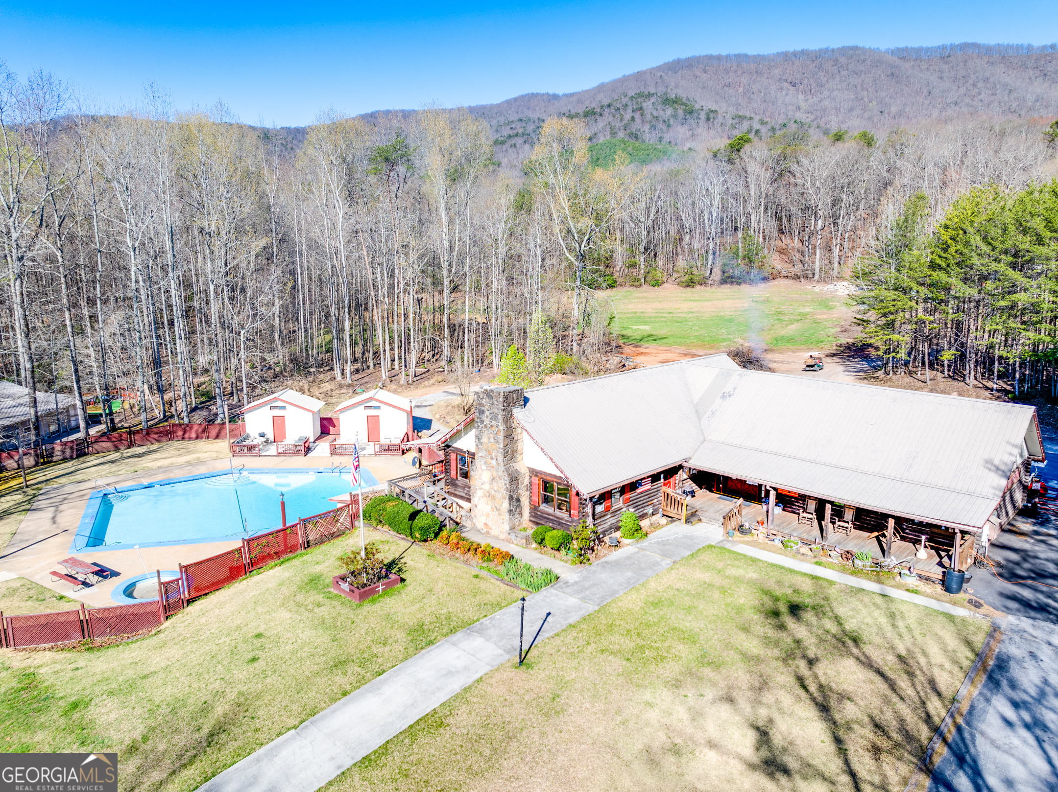4 Evergreen Trail, Unit B22 Cleveland, GA 30528 - Photo 15 of 33 a view of a swimming pool with a yard and mountain in the back