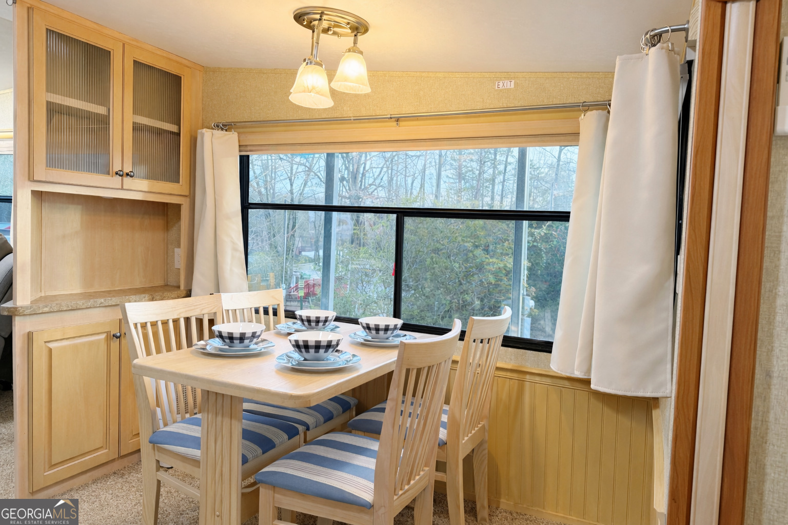 4 Evergreen Trail, Unit B22 Cleveland, GA 30528 - Photo 5 of 33 a view of a dining room with furniture large windows and wooden floor