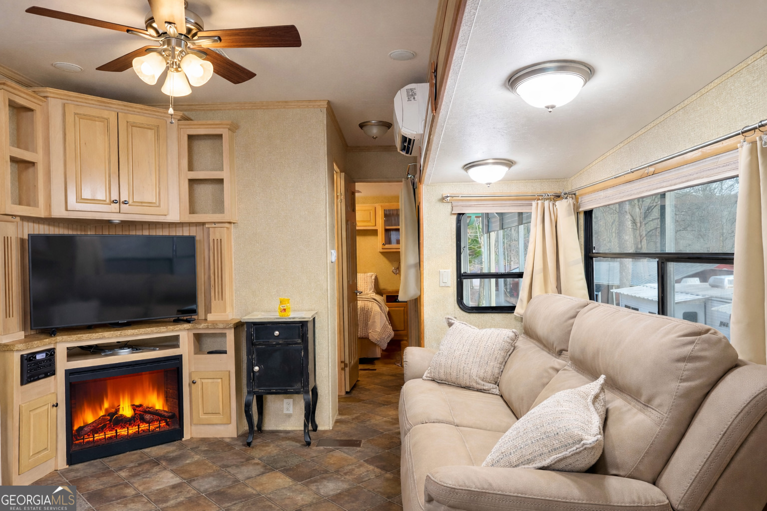 4 Evergreen Trail, Unit B22 Cleveland, GA 30528 - Photo 6 of 33 a living room with furniture a flat screen tv and a fireplace