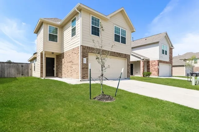 a front view of a house with a garden and plants