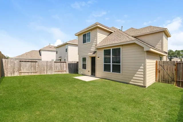 a view of a house with a yard and porch