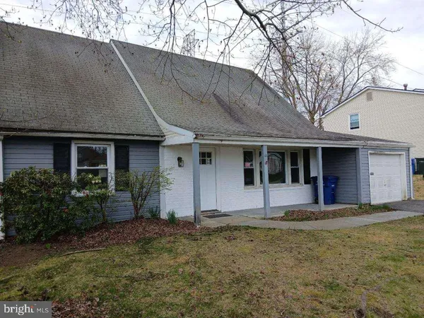 a view of a house with a backyard and a patio