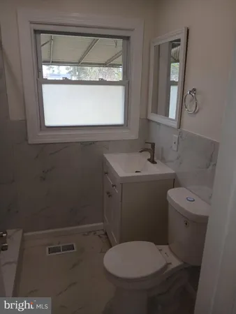 an empty room with wooden floor and a window