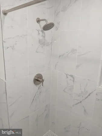 a view of a room with wooden floor and windows in it