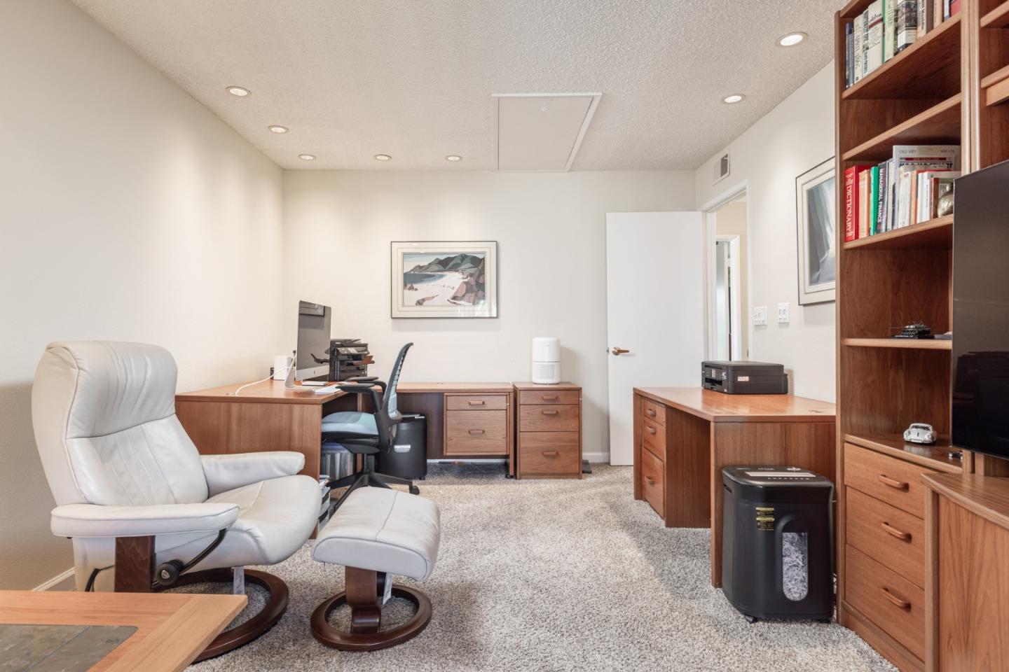 1360 Josselyn Canyon Road, Unit 40 Monterey, CA 93940 - Photo 17 of 18 a living room with furniture and a flat screen tv