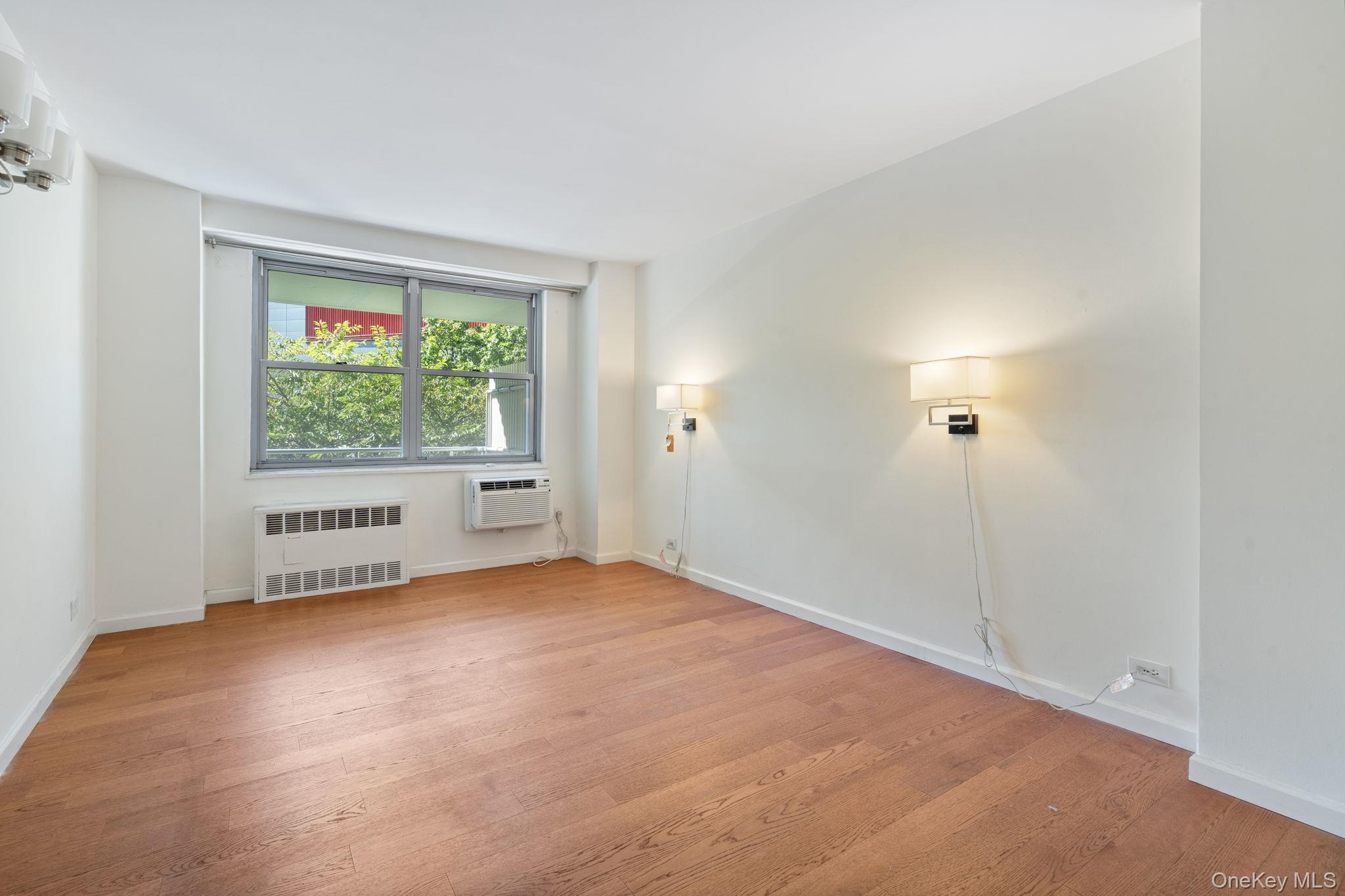 61-15 97th Street, Unit 2D Queens, NY 11374 - Photo 5 of 11 an empty room with windows