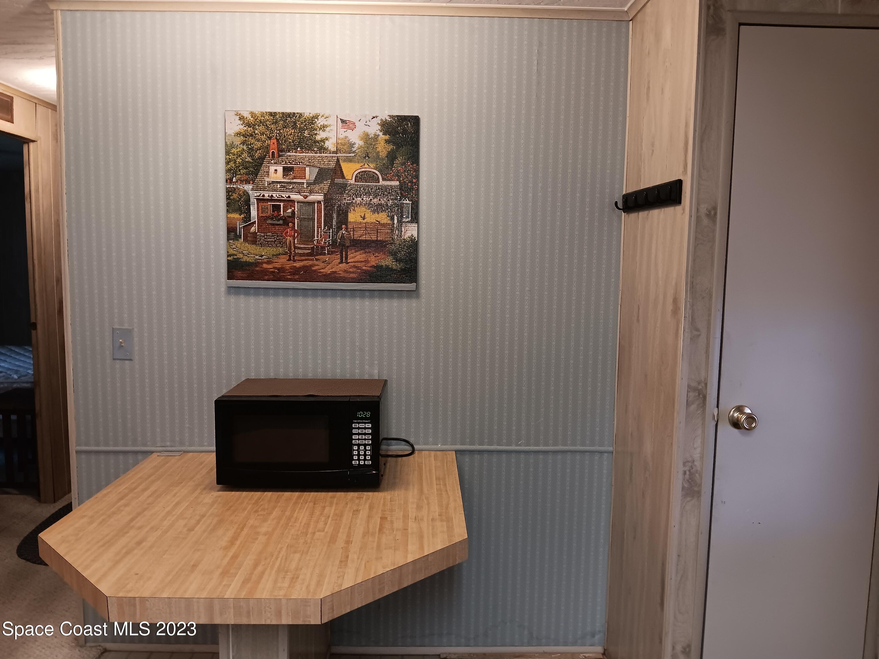 511 Puffin Drive Barefoot Bay, FL 32976 - Photo 11 of 25 a room with table and chair