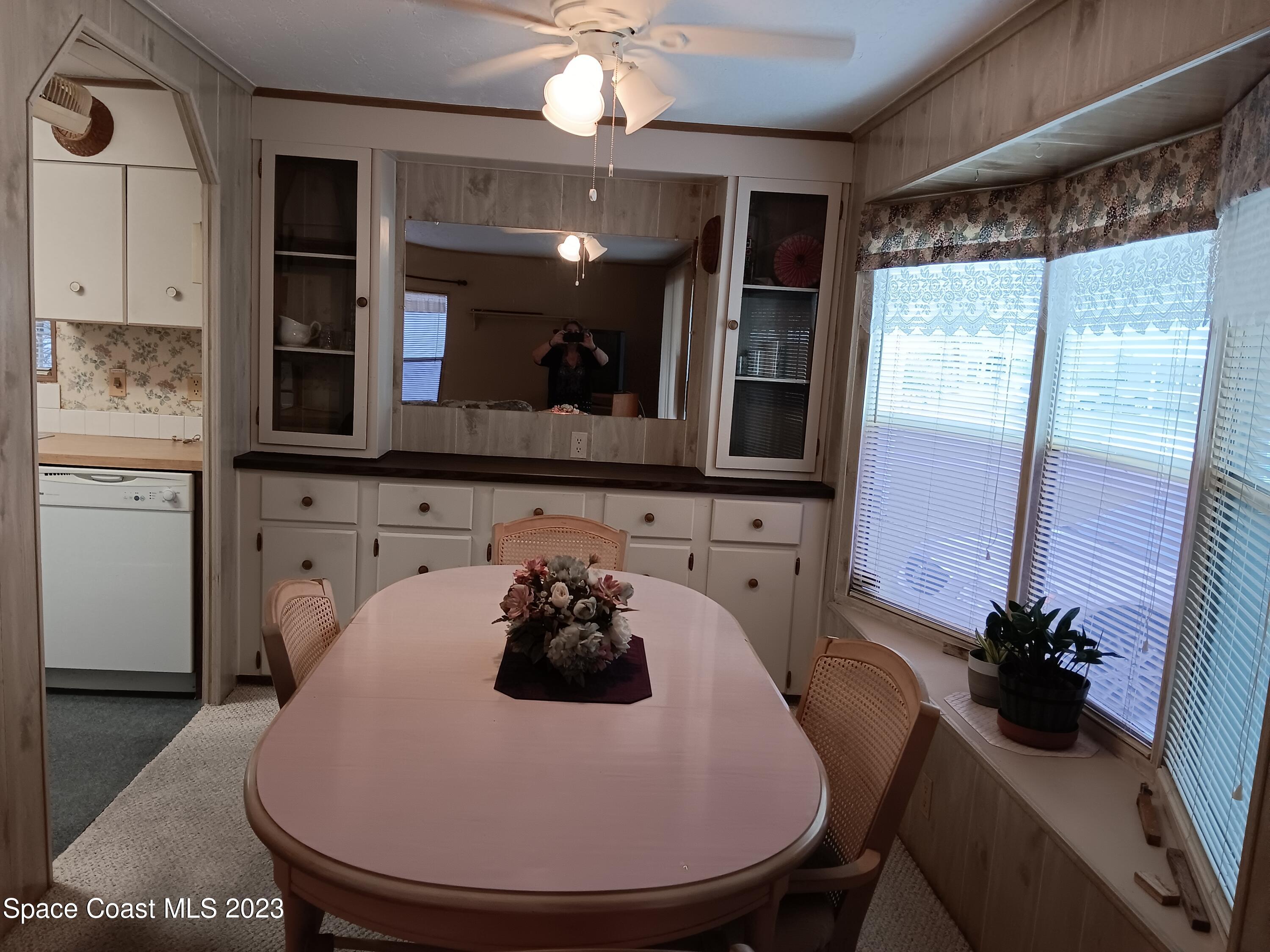 511 Puffin Drive Barefoot Bay, FL 32976 - Photo 12 of 25 a kitchen with a table and chairs in it