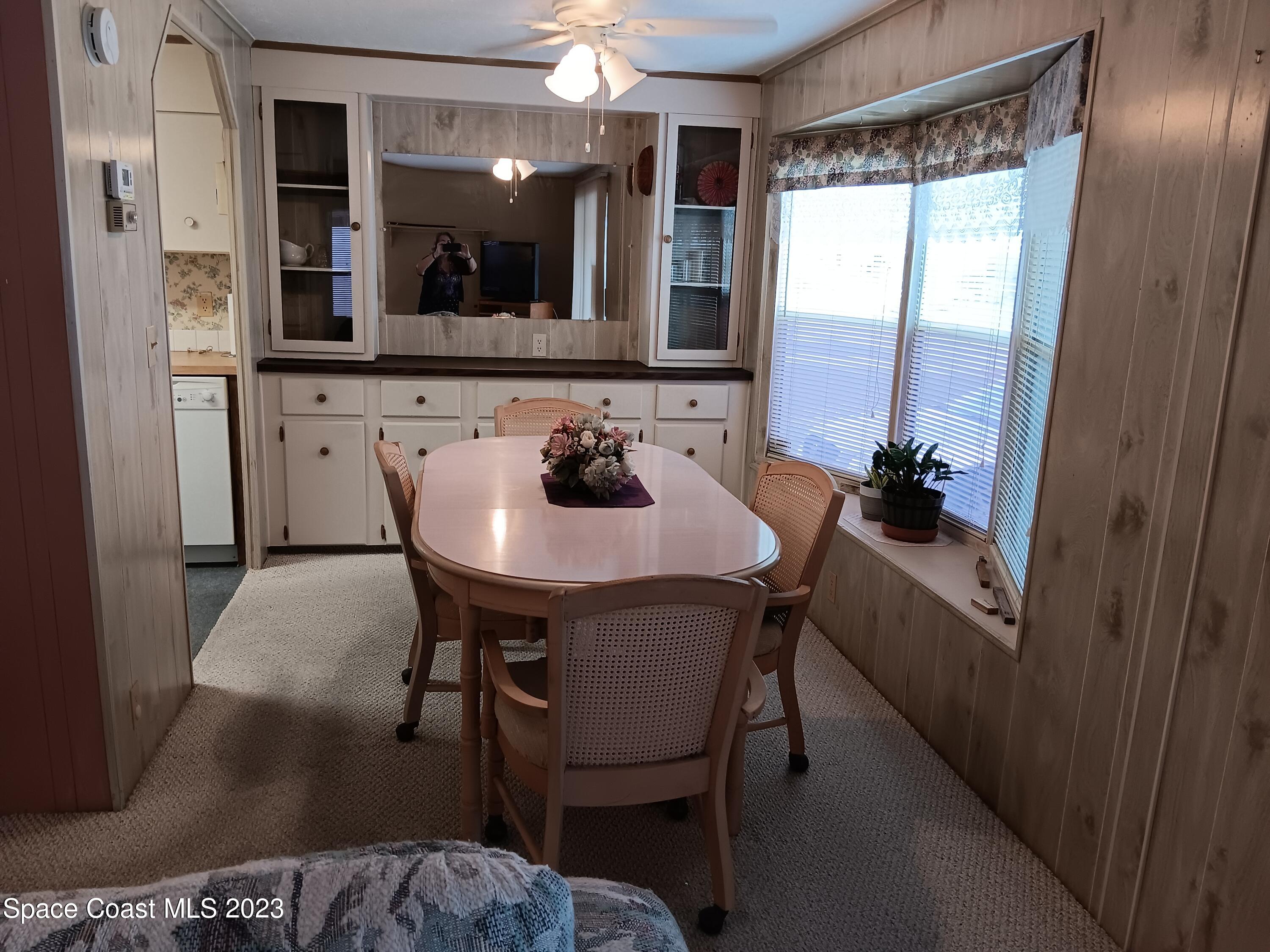 511 Puffin Drive Barefoot Bay, FL 32976 - Photo 13 of 25 a dining room with furniture and window