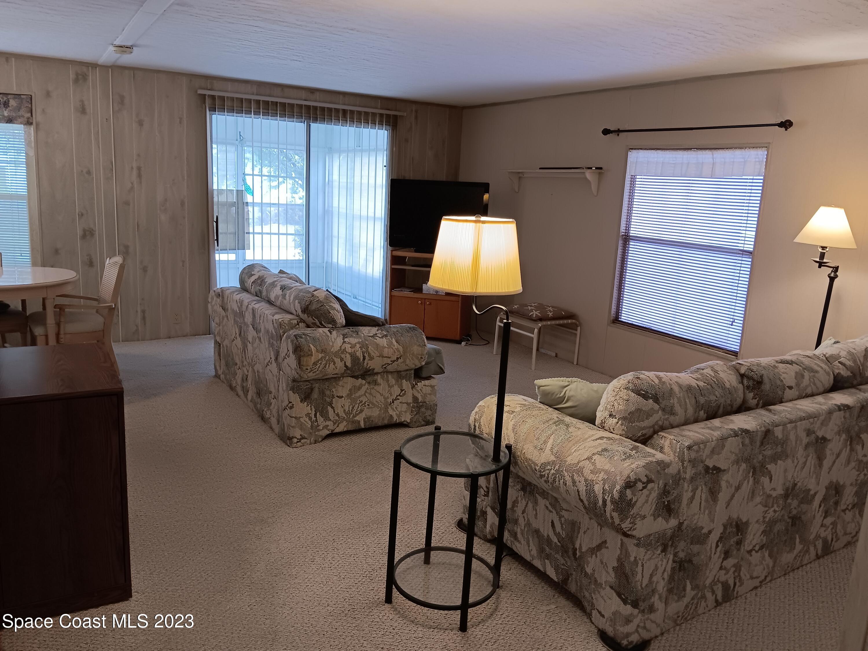 511 Puffin Drive Barefoot Bay, FL 32976 - Photo 15 of 25 a living room with furniture and a window