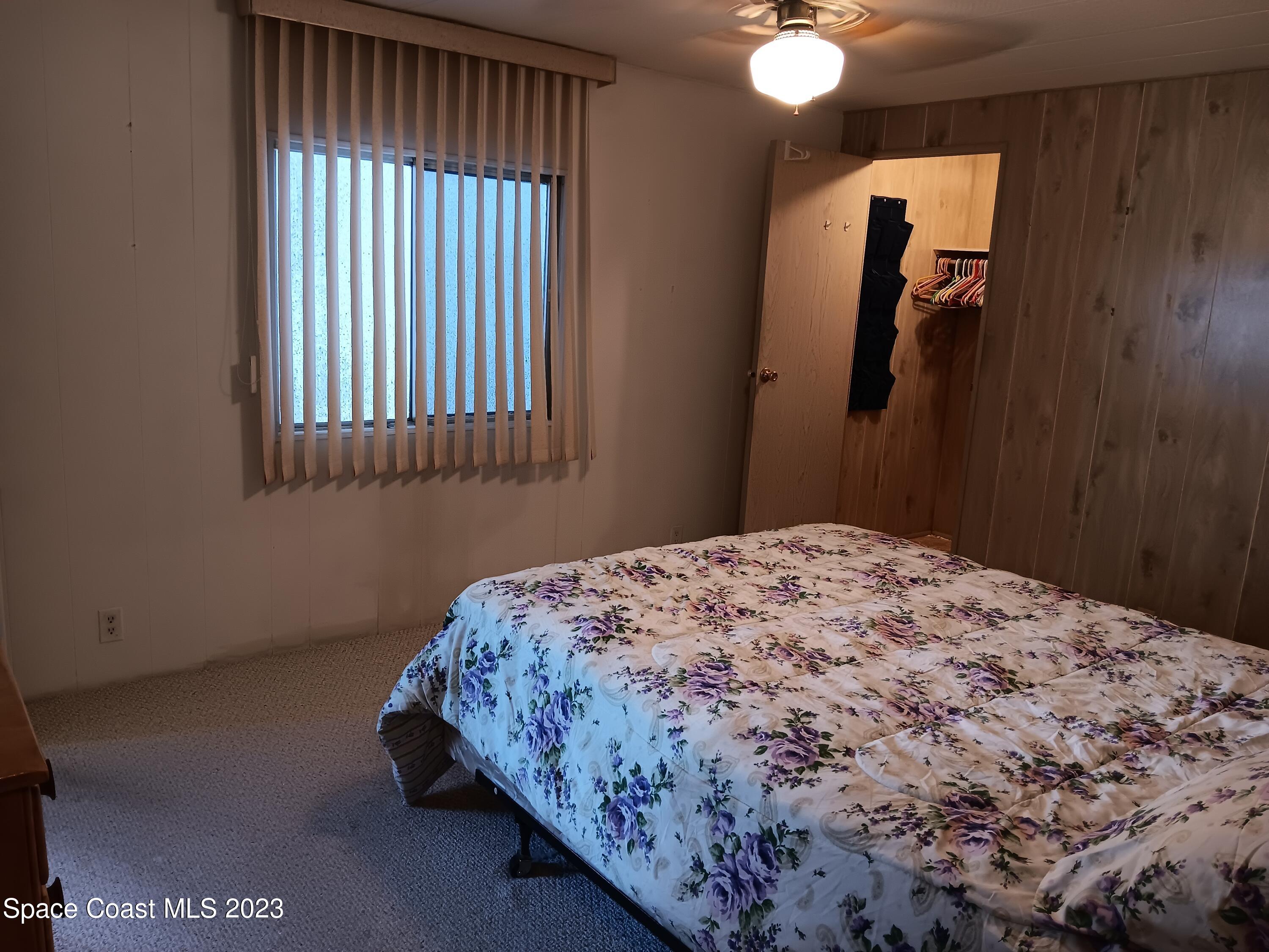 511 Puffin Drive Barefoot Bay, FL 32976 - Photo 19 of 25 a bedroom with a bed and a window