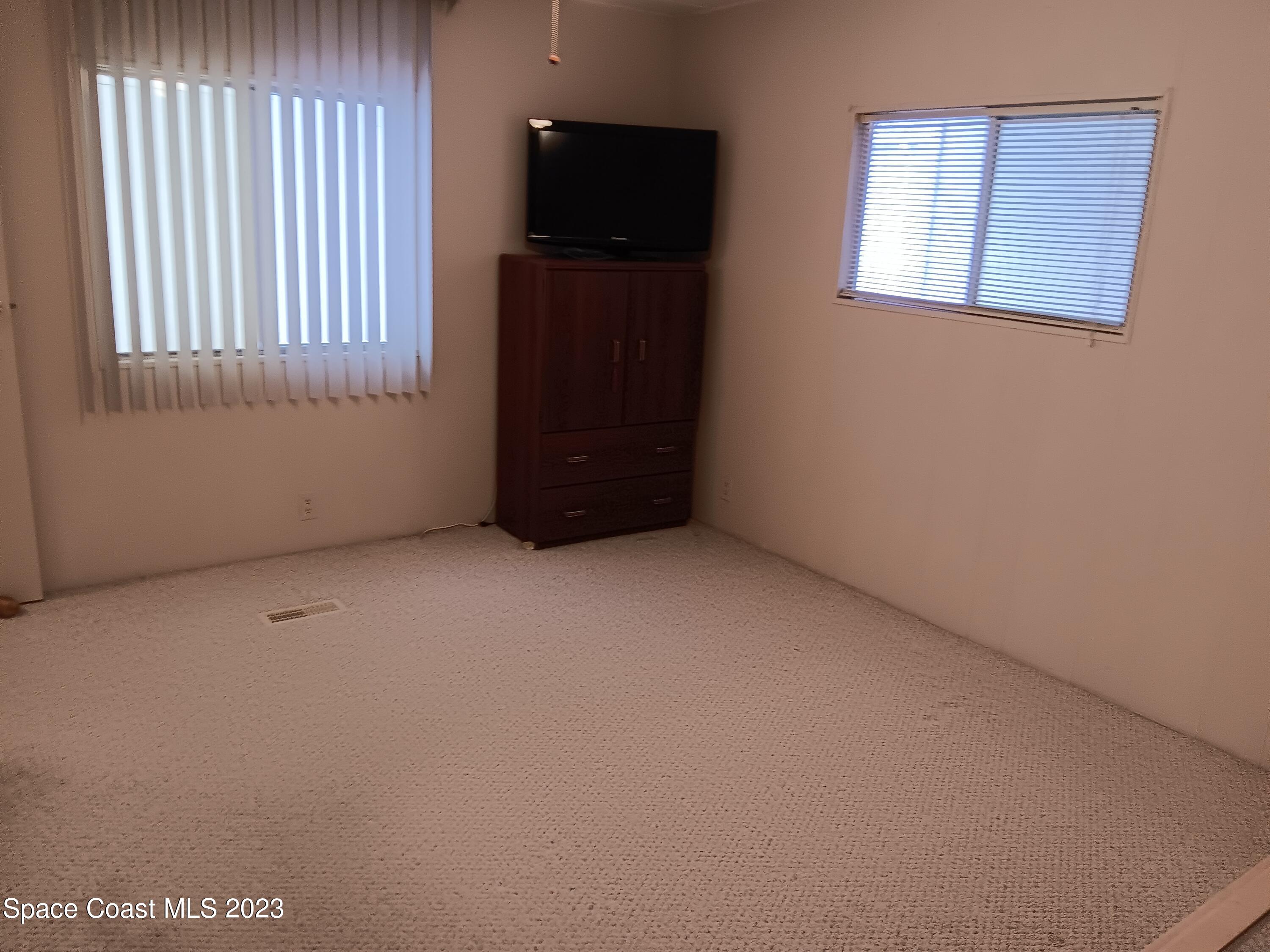 511 Puffin Drive Barefoot Bay, FL 32976 - Photo 23 of 25 a view of an empty room with a window
