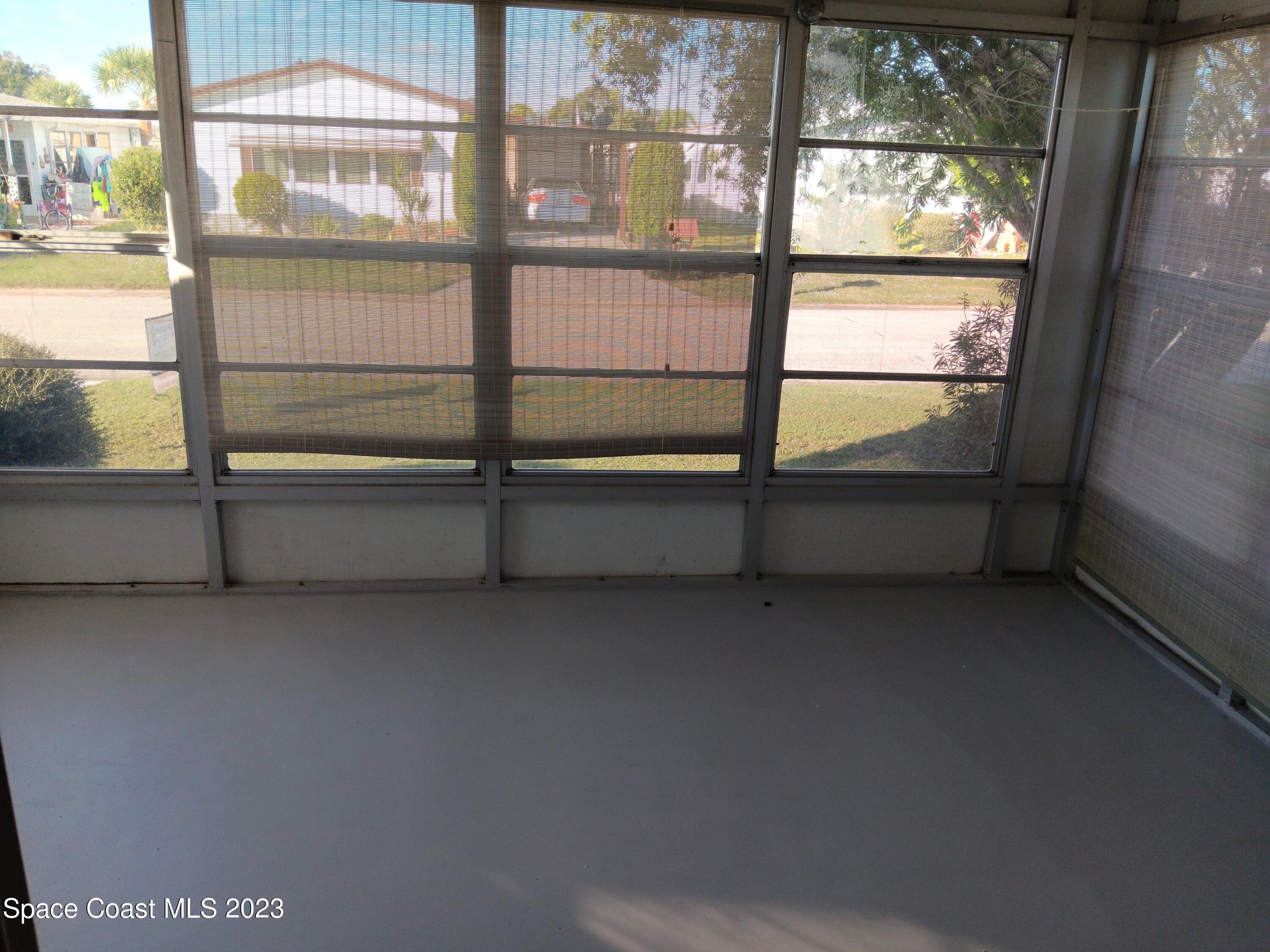 511 Puffin Drive Barefoot Bay, FL 32976 - Photo 7 of 25 a view of an empty room with a window