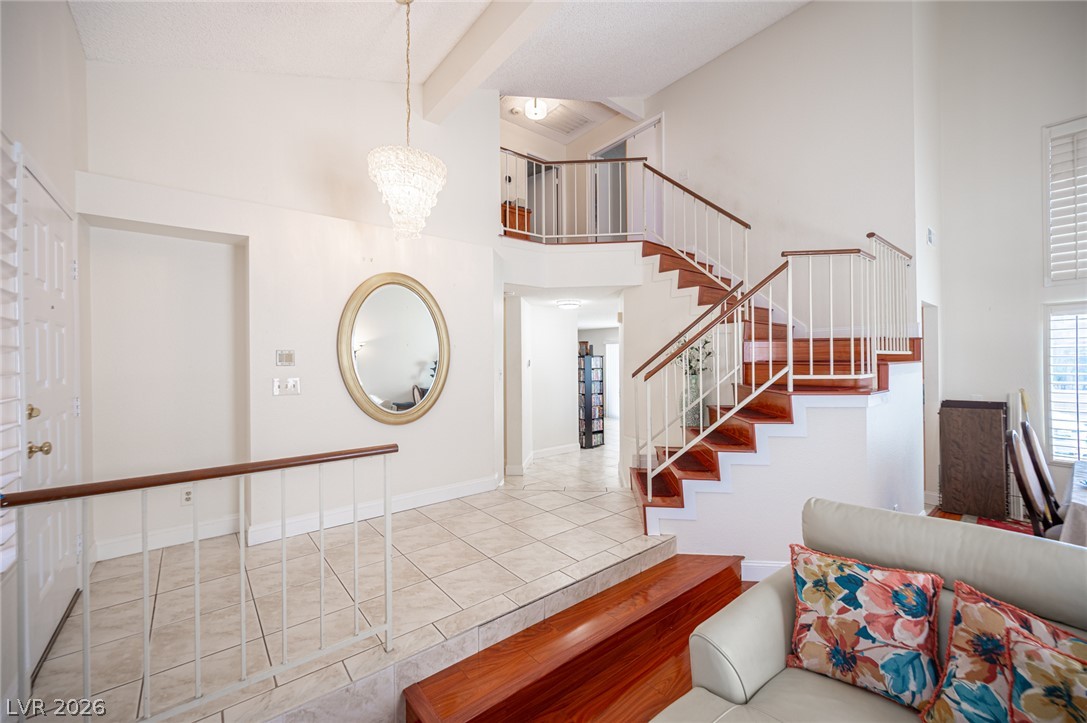 718 Rusty Spur Drive Henderson, NV 89014 - Photo 8 of 50 A grand entrance with an impressive two-story staircase leading to a spacious upper landing.
