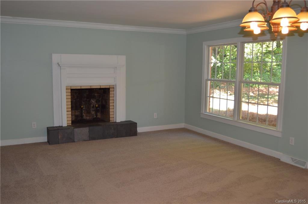 217 Museum Road Statesville, NC 28625 - Photo 11 of 19 an empty room with windows and fireplace