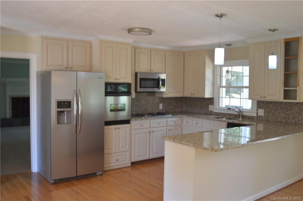 217 Museum Road Statesville, NC 28625 - Photo 6 of 19 a kitchen with stainless steel appliances granite countertop a refrigerator a stove and a sink