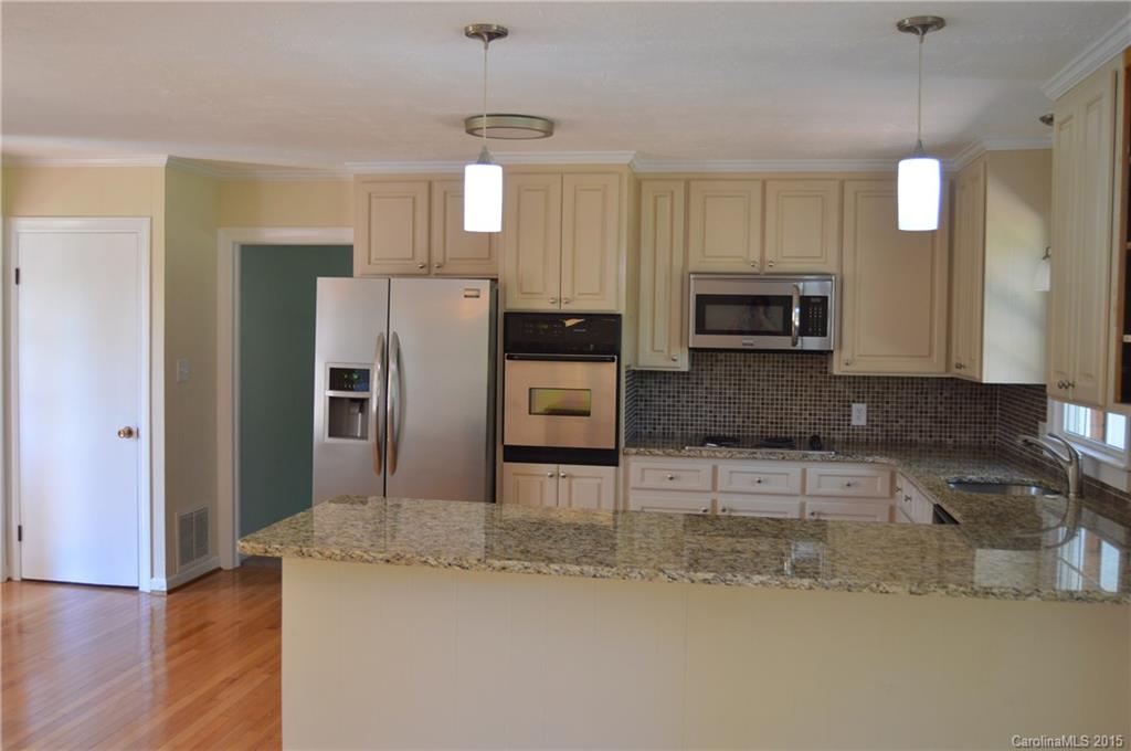 217 Museum Road Statesville, NC 28625 - Photo 7 of 19 a kitchen with stainless steel appliances granite countertop a refrigerator a stove top oven a sink and dishwasher